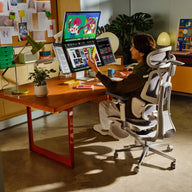 Person using a high-tech gaming chair in a modern office setting~scene