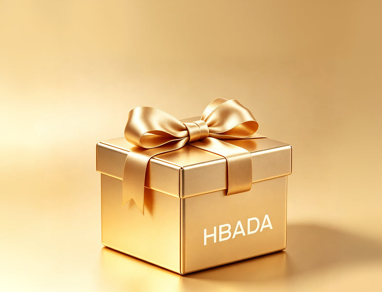 Closed gold HBADA gift box with a ribbon bow